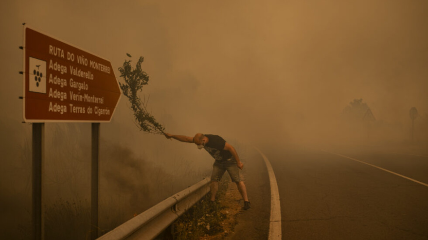 Title: Burned LandCredit: © Brais Lorenzo, EFE, Revista 5W, El PaísCaption: A man fights a wildfire with a branch in Cualedro. When resources are stretched, residents use whatever is available to extinguish flames, including branches, farming tools, and water hoses. Ourense, Galicia, Spain, 15 August 2025.Story: 2025 was a record year for wildfires in Europe. More than 200,000 hectares burned across Galicia during Spain’s worst fire season in about three decades. The increasingly severe fires in this region are attributed to drought and heat intensified by climate change, rural depopulation, and shortsighted forest management policies, including the widespread planting of highly flammable non-native species. Born in Ourense, the photographer grew up with the smell of smoke every summer and has documented Galician wildfires since 2011.