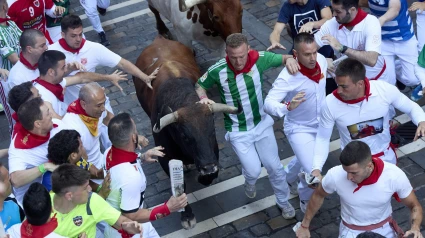 July 8, 2025, Pamplona, Navarre, Spain: People take part in the traditional 'encierro' (bull-run) of the San Fermin Festival in Pamplona, Spain on July 08, 2025. The bull-running fiesta is held annually from 06 to 14 July in commemoration of the city's patron saint. Visitors from all over the world attend the festival. Many of them physically participate in the highlight event - the running of the bulls, or encierro - where they attempt to outrun the animals along a route through the narrow streets of Pamplona's old city. (Credit Image: © Ruben Albarran/ZUMA Press Wire)