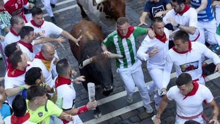 July 8, 2025, Pamplona, Navarre, Spain: People take part in the traditional 'encierro' (bull-run) of the San Fermin Festival in Pamplona, Spain on July 08, 2025. The bull-running fiesta is held annually from 06 to 14 July in commemoration of the city's patron saint. Visitors from all over the world attend the festival. Many of them physically participate in the highlight event - the running of the bulls, or encierro - where they attempt to outrun the animals along a route through the narrow streets of Pamplona's old city. (Credit Image: © Ruben Albarran/ZUMA Press Wire)