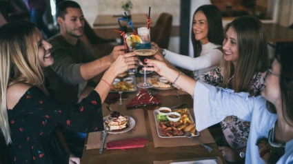 Cheerful friends toasting at restauran