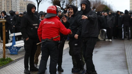 Agentes de la Ertzaintza hablan con aficionados griegos antes del partido en San Sebastián.