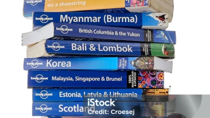 Eindhoven, The Netherlands - July 25, 2015: A stack of Lonely Planet travel guidebooks isolated on a white background