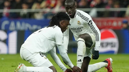 Camavinga ayuda a Mendy a atarse las botas durante el partido de este miércoles en el Metropolitano.