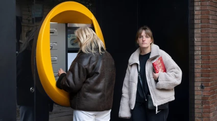 Los clientes retiran dinero de un cajero automático en la sucursal de CaixaBank, la caja de ahorros más grande de España.