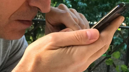 S3JH8R S3JH8R Man using smartphone.