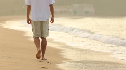 Hombre de espaldas paseando por la playa