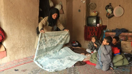 Un aldeano usa una manta donada por China en una zona afectada por un terremoto en la provincia de Herat, Afganistán.