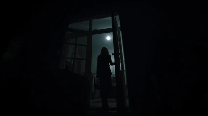 Una mujer entra por la ventana de una casa