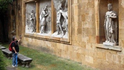 Un turista saca una foto en el Jardín de los Reyes Caudillos, junto a la Catedral de Oviedo