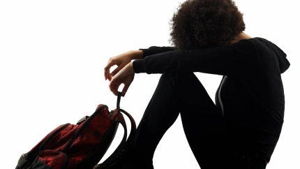 KXBYJ5 one mixed race african young teenager girl woman sadness depression in studio shadow silhouette isolated on white background