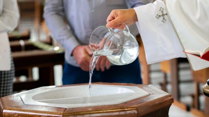 Holy water used to initiate a child, through baptism, in the Christian religio