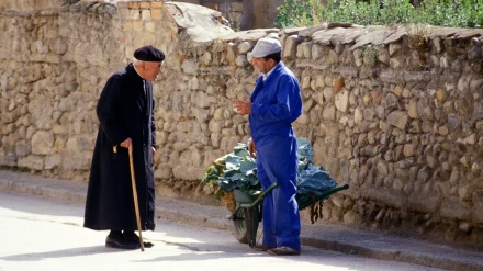 Sacerdote hablando con un trabajador agrícola en Navarredondilla, Ávila