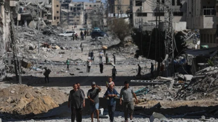 . Palestinos caminan por una calle entre los escombros de los edificios destruidos durante un alto el fuego entre Israel y Hamás, en el marco de la primera fase del plan de paz para Gaza, en la Ciudad de Gaza, Franja de Gaza