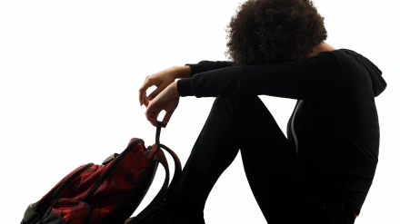 KXBYJ5 one mixed race african young teenager girl woman sadness depression in studio shadow silhouette isolated on white background