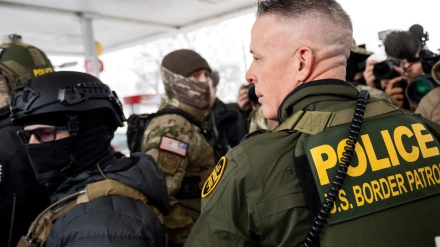 Customs and Border Patrol Chief Greg Bovino stands with federal officers at a gas station. Customs and Border Patrol Chief Greg Bovino and federal immigration agents conducted an enforcement operation in Minneapolis, Minnesota.