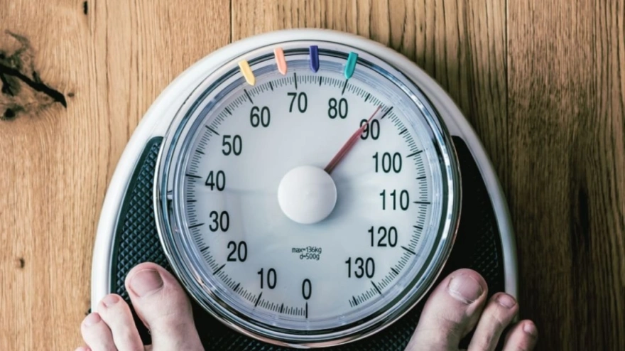 Sports and workout equipment on a wooden floor with healthy snacks, weight loss and physical activity concept