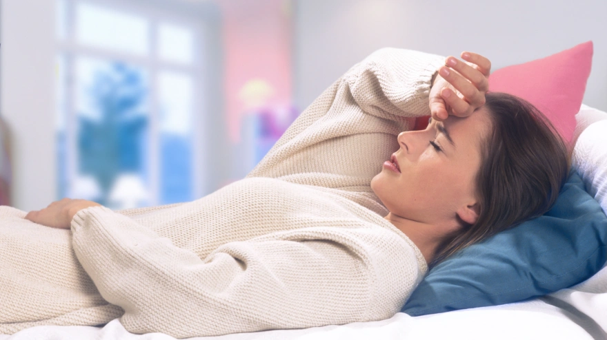 A6B83W ill woman lying on a bed. Image shot 2007. Exact date unknown.