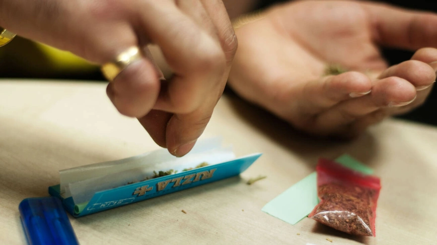 BC0YP6 BC0YP6 Man prepares marijuana joint-Canabis indica