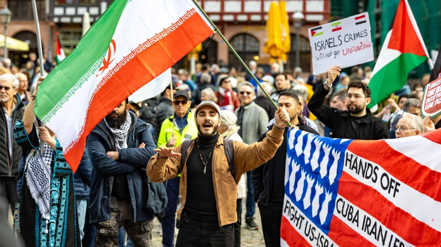 3E6JENM Protester holds Iran flag during Easter March peace demonstration at Romer square.